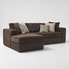 a brown couch and ottoman with pillows on it