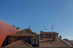 rooftops with tiled roofs against a blue sky