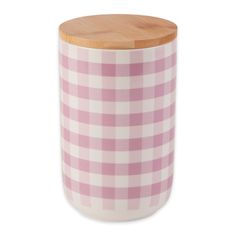 a pink and white checkered canister with wooden lid