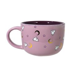 a purple coffee cup with white doves and stars on it