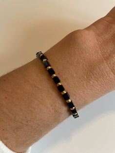 Black cube bead with seed bead color of your choice Cheap Beaded Bracelets With Gold And Black Beads, Adjustable Heishi Bead Jewelry With Black Beads, Adjustable Minimalist Spacer Beads, Adjustable Black Rectangular Beaded Bracelets, Minimalist Stretch Bracelet With Spacer Beads, Adjustable Heishi Beads Bracelet With Faceted Beads, Minimalist Heishi Beads Bracelets, Minimalist Beaded Heishi Bead Jewelry, Minimalist Black Beaded Bracelets For Everyday