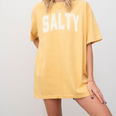 Stylish comfort colors preppy beach style Christian "SALTY" graphic t-shirt with the bible verse Matthew 5:13 underneath. A trendy bright summer color faith apparel shirt gift for Christian teen girls and women.  Wear your faith on your sleeve with this vintage book club aesthetic, Jesus graphic shirt that can be easily dressed up or down. Perfect gift for a Christian friend, or a church outfit.  Available in 7 colorways: Watermelon, Mustard, Blue Jean, Pepper, Espresso, Ivory & Orchid. Size up Vsco Style Letter Print T-shirt For Streetwear, Summer College T-shirt With Screen Print, Trendy Summer T-shirt With Lettering, Casual Summer T-shirt With Lettering, Spring Vsco T-shirt With Text Print, Spring Vsco T-shirt With Letter Print, Summer Short Sleeve T-shirt With Lettering, Summer College T-shirt With Text Print, Summer College Slogan T-shirt