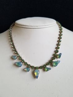 "A 1940's Light Green Opaque Stone & Rhinestone Choker Dream! It's an unsigned Choker with splendid Opaque stones and Lime Green Glass Rhinestones. The base metal is a Silver Tone metal with cups to hold each stone. At the end is a large hook used as a clasp. The choker measures: 15\"L and is in great vintage condition. All stones and Rhinestones are intact with non-missing. It will arrive just in time for St. Patrick's Day in a gift box with FREE SHIPPING. Measures: 15\"L Stones from center 1950s Hollywood Glamour, 1950s Hollywood, Vintage Rhinestone Jewelry, Rhinestone Choker, Rhinestone Bridal, Holiday Jewelry, Vintage Jewels, Rhinestone Jewelry, Enamel Jewelry