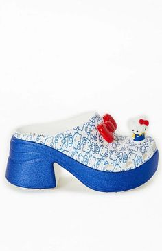 Celebrate Hello Kitty's 50th Anniversary with the Women's Hello Kitty Siren Clog, designed for fans who want a super cute update to their Crocs collection. Featuring bold, sparkly high heels and unbeatable comfort, this silhouette is perfect for all occasions..9.2cm / 3.6-inch heel height.Includes Hello Kitty red bow and figure Jibbitz™ charms.Hello Kitty graphics all over upper.Sparkly sole.Hello Kitty logo on footbed.Molded TPU heel cup.Ventilation ports add breathability and help shed water and debris.Easy to clean and quick to dry.Customizable with other Jibbitz™.Iconic Crocs Comfort™: Lightweight. Flexible. 360-degree comfort. Cute Synthetic Heels, Playful Synthetic Clogs With Round Toe, Crocs Shoes Women, Hello Kitty Logo, Crocs Collection, Sparkly High Heels, 6 Inch Heels, Clog Sandals, Crocs Shoes