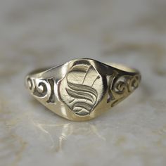 Antique 14k gold signet ring with a hand engraved letter "S" on the face. It has hand-done openwork swirls on the sides of the band. Marked 14k. Era: Victorian c.1900 Markings: 14k Materials: 14k gold Face Measures: 10.92mm  Ring Size: 9 (comes with one free resizing by our jeweler) Weight: 2.4 grams  Condition: Excellent antique condition with minor surface wear from age  Shipping is free in the United States Follow us on Instagram @LUXXORVintage Luxury Engraved Rectangular Ring With Polished Finish, Victorian Yellow Gold Rings With Engraving Option, Victorian Style Yellow Gold Rings With Engraving Option, Victorian Engraved Signet Promise Ring, Victorian Yellow Gold Ring With Engraving Option, Antique Hallmarked White Gold Signet Ring, Victorian Initials Signet Ring For Anniversary, Vintage Yellow Gold Engraved Initial Ring, 14k Gold Engraved Signet Ring Collectible