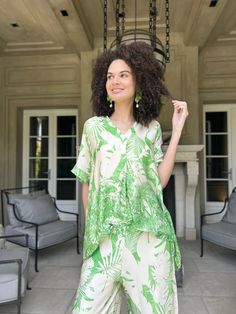 Elevate your wardrobe with the Makayla Jungle Print Top. Crafted from a luxurious blend of 80% viscose and 20% silk, it offers a silky-smooth feel and airy comfort. Versatile enough to be worn separately or paired with matching pants, it's perfect for loungewear or resort chic. The vibrant jungle print adds a touch of exotic flair, while its one-size-fits-all design comfortably accommodates sizes from small to large. Experience comfort and style in one effortlessly chic top. -One size-fits a Sma Chic Short Length Tops For Vacation, Green Viscose Top For Vacation, Green Viscose Tops For Vacation, Green Short-length Tops For Vacation, Green Short Length Tops For Vacation, Green Short Length Top For Day Out, Spring Loungewear Blouse In Viscose, Chic Vacation Blouse Made Of Rayon, Vacation V-neck Viscose Blouse