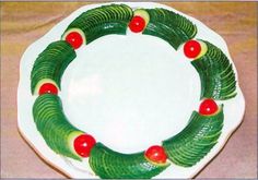 a white plate with green and red decorations on it