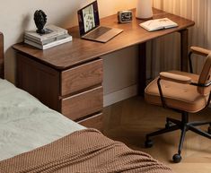 a bedroom with a bed, desk and chair