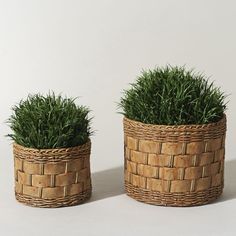 two woven baskets with grass in them