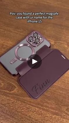 an iphone case with the name finn on it, sitting on top of a wooden table