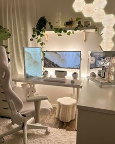 a computer desk with two monitors and a white chair