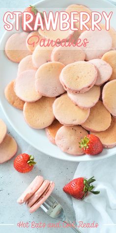 a white plate topped with heart shaped cookies and strawberries