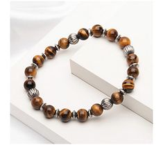 Elevate your laid-back style with this handsome tiger's eye beaded bracelet with stainless steel accents. From Verve. Tiger Eye Beads, Tiger's Eye, Laid Back Style, Men's Jewelry, Tiger Eye, Handmade Bracelets, Beaded Bracelet, Mens Bracelet, Mens Jewelry