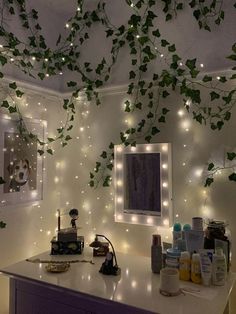 a bathroom with lights and plants hanging from the ceiling above it, along with other items