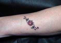 a woman's arm with a small tattoo on it