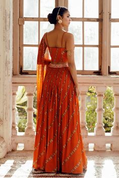 Orange printed gathered lehenga with embroidered waistband. Paired with embroidered padded bustier and cutwork dupatta. - Aza Fashions Bohemian Embellished Wedding Sets, Bohemian Embellished Lehenga For Weddings, Bohemian Embellished Wedding Lehenga, Summer Lehenga For Reception With Traditional Drape, Summer Reception Lehenga With Mirror Work, Summer Wedding Lehenga With Mirror Work, Summer Lehenga With Cutdana For Reception, Bohemian Embellished Lehenga With Traditional Drape, Summer Reception Lehenga With Cutdana Detail