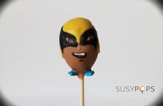 a close up of a cake on a stick with the face of an animated character