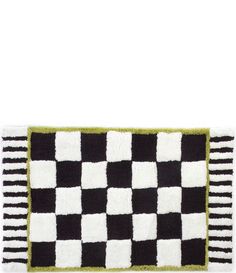 a black and white checkered rug with green trim on the bottom, in front of a white background