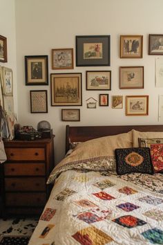 a bed with many pictures on the wall above it