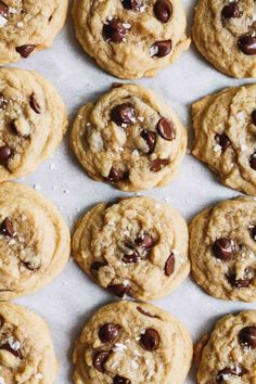 chocolate chip cookies on a baking sheet lined with parchment paper, ready to be eaten