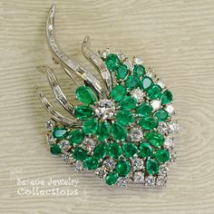 Stunning burst of vivid green emeralds and sparkly white diamonds covering all the surfaces of this beautiful platinum vintage brooch! Total Weight: 29.15 grams Size: 2.5 inch tall, 1.5 inch wide Precious Metal: Platinum Precious stones: -Emeralds: QTY: 31, 2.7mmx4.7mm to 4.2mmx6.3mm size, 7.5 carats -Diamonds: 29 rounds, 20 baguettes, 6 carats Vintage Green Diamond Brooches, Green Diamond Wedding Brooches, Elegant Green Diamond Brooch, Luxury Green Brooch For Anniversary, Luxury Green Brooches For Anniversary, Green Fine Jewelry Brooches For Wedding, Fine Jewelry Green Brooch For Anniversary, Fine Jewelry Green Brooches For Anniversary, Green Fine Jewelry Brooch For Anniversary