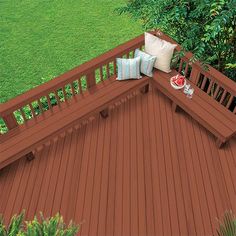 an overhead view of a wooden deck with pillows on it