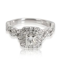 a white gold ring with diamonds on the sides and a square cut diamond in the center