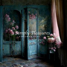 an old blue door with pink flowers in it