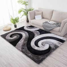 a living room with a couch and rugs on the floor