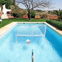 a pool with a soccer goal and ball in it