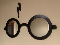 a pair of round mirrors mounted to the side of a wall