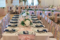 the tables are set with blue and pink linens