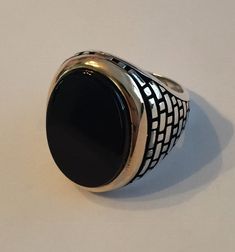 "Gorgeous mens 925 silver black onyx ring. Nice large oval stone 20x23mm (Almost 1\") Solid 925 sterling silver...blackened (oxidized) ridges for a vintage look Bezel of stone is made from solid 10k gold Natural black onyx...semi precious stone! No two ring are alike...gorgeous handmade item! Weighs roughly 13-15 grams depending on ring size Can be worn as a signet ring or as a pinky ring. Even as a ring on your middle or index finger :) We have in sizes 7-13 Ships within 1-2 business days" Formal Black Oval Cabochon Signet Ring, Classic Black Oval Cabochon Ring, Black Oval Signet Ring For Formal Occasion, Formal Black Oval Signet Ring, Formal Black Oval Ring, Formal Black Oval Rings, Oval Black Enamel Ring, Black Sterling Silver Signet Ring With Polished Finish, Black Sterling Silver Signet Ring For Anniversary