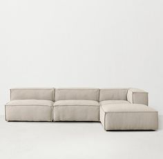 a white couch sitting on top of a white floor