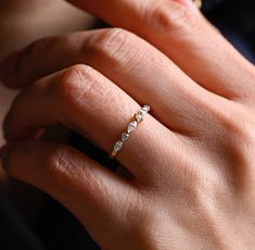 a woman's hand with a diamond ring on it