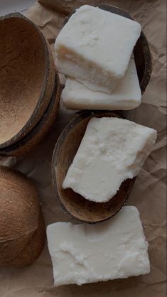 three coconuts and two pieces of white soap on wax paper