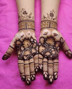 two hands with henna designs on them