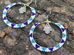 Hamsa Earrings, Native Beaded Hoop Earrings, Ethnic earrings, Hamsa Hand Earrings, white blue earrings, boho earrings, beadwork earrings Hoops are approximately 1.97 inches  (5.1 cm) Hoop beaded earrings. Very lightweight. Fusion between ethnic style and modern elements. Earrings made of quality Czech seed beads - White and blue colors  Cute handmade Earrings is a pleasant gift for you or for one you love. RECOMMENDATION FOR USE AND CARE:  - Do not clean with water and any other liquid. - Keep your handmade jewelry in a closed box far away from sun rays access. Please note that colors may look different on different screen lights. Thank you for your visit! Please, see my shop  https://www.etsy.com/shop/InnaPositiveArt Bohemian White Beaded Hoop Earrings, Handmade Hoop Beaded Earrings For Beach, Handmade Beaded Hoop Earrings For Beach, White Bohemian Dangle Hoop Earrings, Handmade Blue Beaded Small Hoop Earrings, Handmade Blue Round Hoop Earrings, Blue Bohemian Hoop Earrings For Pierced Ears, White Bohemian Small Hoop Beaded Earrings, Blue Bohemian Hoop Earrings