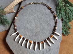 Each one of these necklaces is hand made with real coyote teeth and wooden beads. Only two of these unique pieces are available! The fangs that I use to make these necklaces are 3 cm long. The length of the necklace can be adjusted through a lobster claw and rings, between 42 and 47 cm. I create jewelry for those who want to live in closer contact with nature. With my creations I try to evoke ancient and tribal feelings that I hope will make you fall in love with them! Each one of my products is packaged as lovingly as it was created and delivery is free worldwide! For any questions don't hesitate to contact me, I will get in touch as soon as possible. I also make custom jewelry! Unique Adjustable Bone-colored Necklace, Bone Color Bohemian Adjustable Necklace, Unique Adjustable Bone Colored Necklace, Bohemian Bone-colored Necklace For Festivals, Unique Adjustable Bone Necklace, Adjustable Bone-colored Jewelry For Festivals, Adjustable Bone-colored Jewelry For Festival, Adjustable Bone Color Jewelry For Festival, Teeth Charms