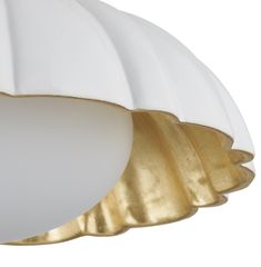 a white and gold lamp hanging from the ceiling