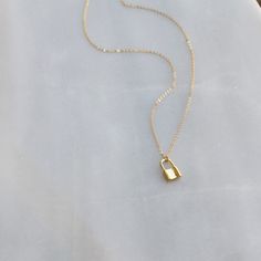 "Tiny Lock Necklace DETAILS -Tiny Lock charm approx. 7mm -Lock is gold plated or silver plated -A high quality delicate link chain with a spring clasp -Chain is 14kt gold filled or sterling silver LENGTH -Measures 16 inches with a 1 1/2 inch extender for a total length of 17 1/2 inches. -You can wear this at 16 inches or 17 1/2 inches. -Also available in 16, 18 or 20 inches with no extender. -Model is wearing 16\" in photos. ∙ EXTRA LOVE ∙ Crafted and curated just for you in the desert of our Ar Minimalist Everyday Jewelry With Lock Detail, Elegant Everyday Necklaces With Lock Detail, Everyday Silver Necklace With Lock Detail, Silver Lock Necklace Gift, Silver Necklace With Lock Gift, Silver Necklace With Lock As Gift, Gold Chain Necklace With Lock For Gift, Minimalist Jewelry With Lock As A Gift, Minimalist Lock Jewelry For Gifts