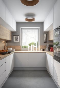 a kitchen with white cabinets and counter tops