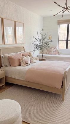 a bed room with a neatly made bed and two mirrors on the wall above it