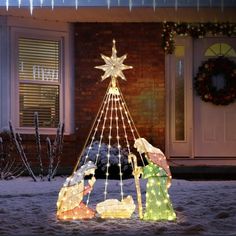 lighted nativity scene in front of a house