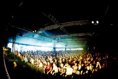 a large group of people sitting on top of a stage