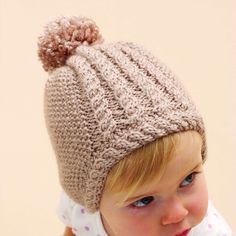 Free Intermediate Knit Hats Pattern For BabyA delicate hat with cable trim makes a darling gift for any tiny tot. Bernat Softee Baby is OEKO-TEX Standard 100 certified, so it's always safe to use. Select your color and let's get you on your way to completing a warm hat that looks priceless. Baby Hat Knitting Pattern, Baby Knitting Patterns Free, Baby Hats Knitting, Knit Hats, Knitting Supplies, Baby Yarn, Hat Knitting Patterns, Free Knitting Pattern, Baby Sweaters