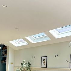 a living room filled with furniture and skylights