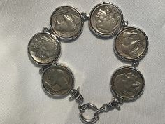 Vintage sterling silver bracelet with 6 Native American coins (shows  faces of  Native Americans). This simple, classic bracelet is a collector's item that will gain value with time. Makes a great gift. 8  inches long 1 inch in diameter Classic Sterling Silver Nickel-free Bracelet, Nickel-free Classic Sterling Silver Bracelet, Antique Nickel-free Bracelets, Collectible Hallmarked Bracelets, Nickel-free Classic Collectible Jewelry, Classic Collectible Nickel-free Jewelry, Classic Nickel-free Collectible Jewelry, Vintage Silver Coin Bracelets, Vintage Silver Coin Bracelet