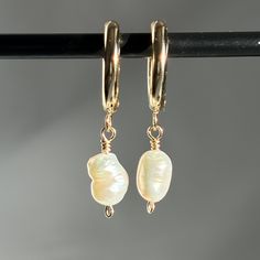 Our Freshwater Pearl Huggie Hoops are the perfect gift for her or gift for loved one! Made with 24k Gold Plated Stainless Steel, it is bound to last a long time with proper care! MATERIALS & COMPONENTS * Made with your choice of Silver Plated Stainless Steel Huggie Hoops, 925 Sterling Silver Wire & natural Mother of Pearl or 24k Gold Plated Stainless Steel Huggie Hoops & 14k Gold Filled wire. * Tarnish resistant * Skin friendly * 6-9mm Pearls  * Your choice of 16mm or 20mm Hoops JEWELLERY CARE Although Gold/Silver Plated Stainless Steel & 14k Gold Filled/Sterling Silver jewellery is water and tarnish resistant, we want your new fave hoops to last as long as posssible. * Avoid swimming in the sea & swimming pools * Avoid wearing your jewellery when showering and exercising * Put on perfumes 14k Gold Filled Huggie Matching Earrings, Gold Plated Huggie Jewelry For Gifts, Yellow Gold Hoop Earrings With Pearl Drop For Gift, Elegant Adjustable Huggie Earrings For Anniversary, Small Hoop Clip-on Earrings As Gift, Nickel Free Small Hoop Earrings For Gift, Gift Huggie Clip-on Earrings, Hoop Clip-on Earrings As Gift, 14k Gold-filled Pearl Drop Huggie Jewelry