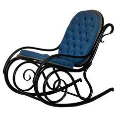 a black rocking chair with blue cushions on it's back and arms, against a white background